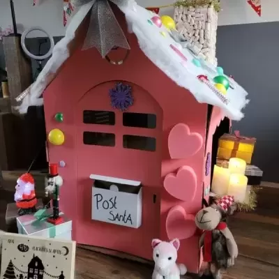 Casinha decorativa rosa de Natal com laço prateado e caixa de correio Post Santa