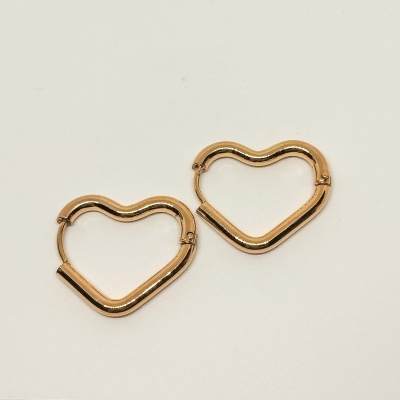 Brincos dourados em forma de coração sobre fundo branco