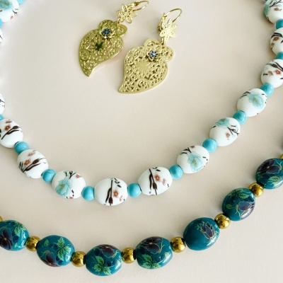 Colares com contas florais e brincos dourados com pedra azul