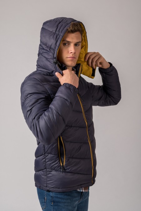 Casaco acolchoado azul escuro com capuz e fecho amarelo
