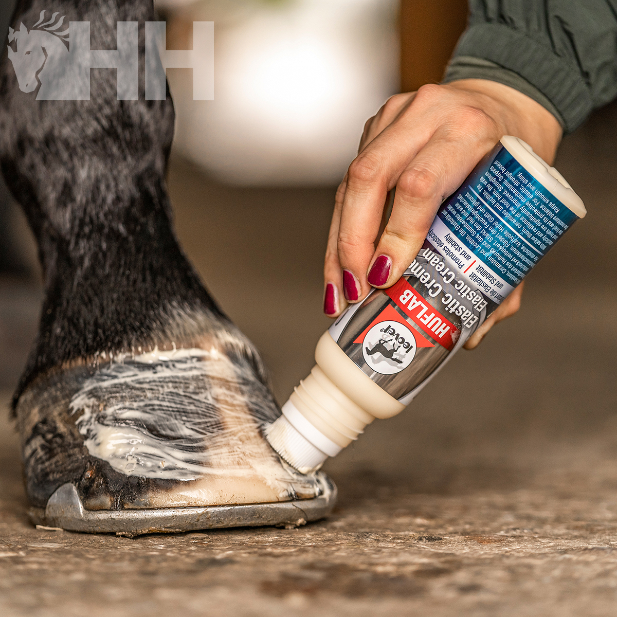 Mão a aplicar creme em casco de cavalo com frasco rotulado HUF LAB.