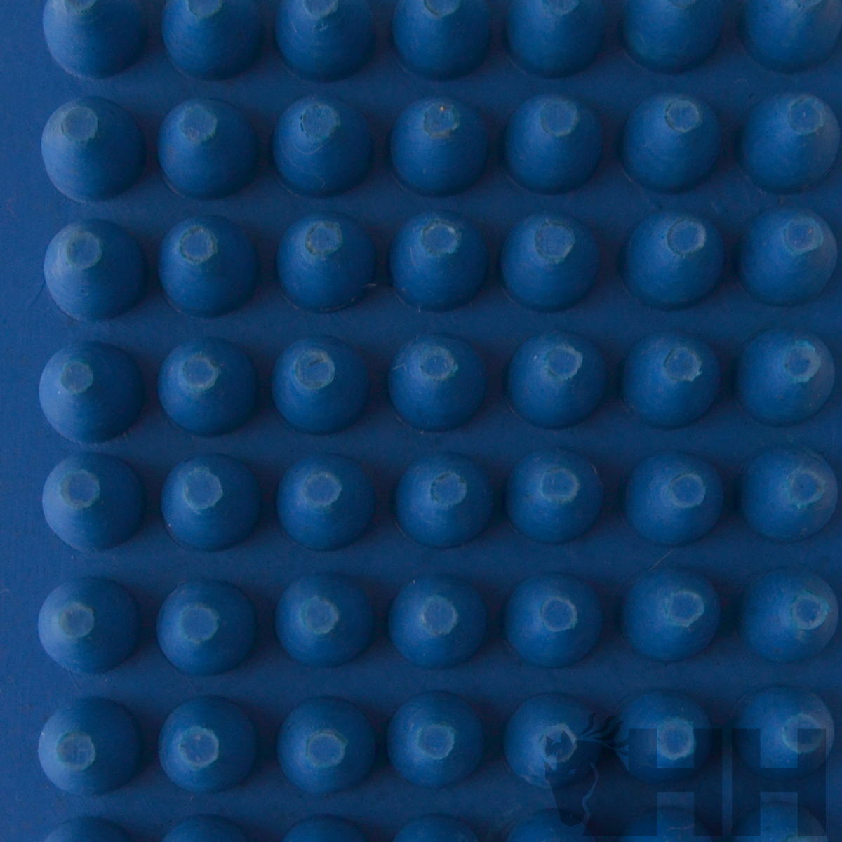 Superfície azul com protuberâncias redondas em relevo