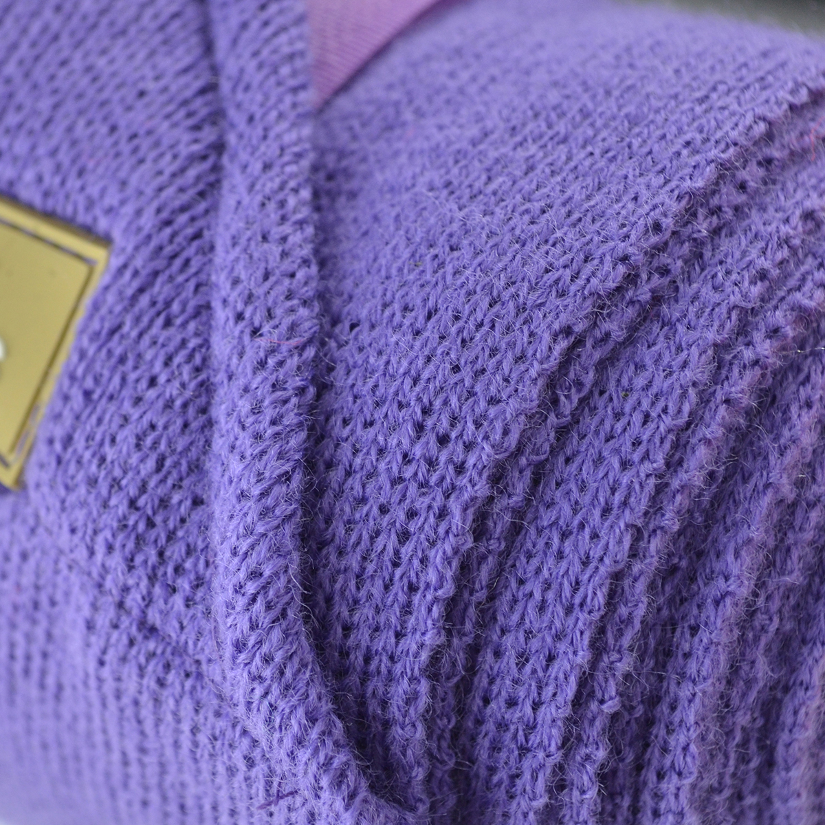 Pano roxo de malha com etiqueta dourada