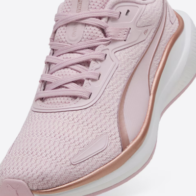 Ténis desportivos Puma cor de rosa com detalhes metálicos dourados e sola branca.