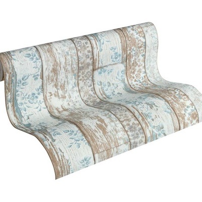 Rolo de papel de parede em padrão azul, castanho e bege com motivos florais e riscas