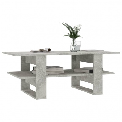 Mesa de centro cinza claro com textura de cimento com objetos decorativos numa superfície branca