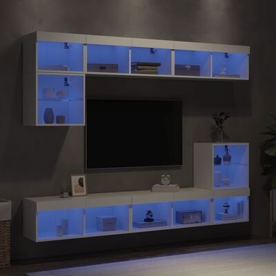Móvel de parede modular branco com prateleiras iluminadas a azul e objetos decorativos.