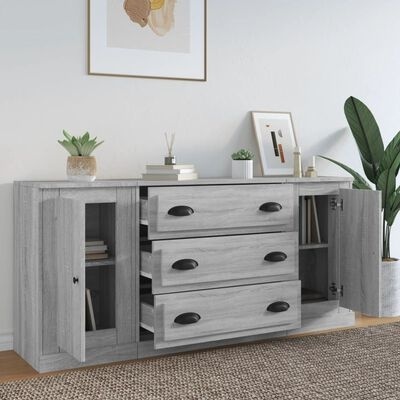 Aparador cinzento com gavetas e portas em vidro e decoração com plantas e livros