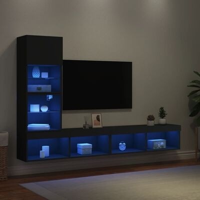 Móvel de sala de estar preto com iluminação LED azul e vários objetos decorativos.