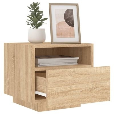 Mesa de cabeceira em madeira clara com gaveta aberta, vaso branco com planta e quadro decorativo