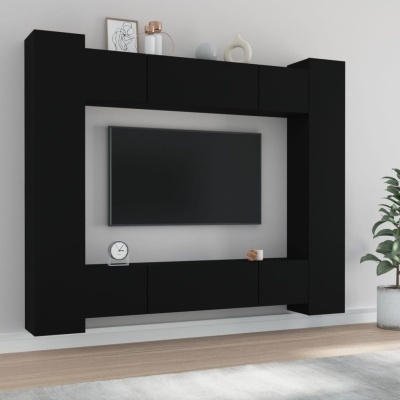 Móvel de sala preto com televisão encastrada e decoração minimalista.