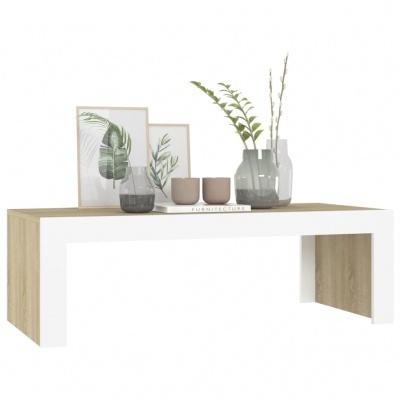 Mesa de centro branca e madeira com vasos, quadros de folhas e livro na superfície