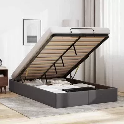 Cama cinza com arrumação interior e base levantada num quarto minimalista.