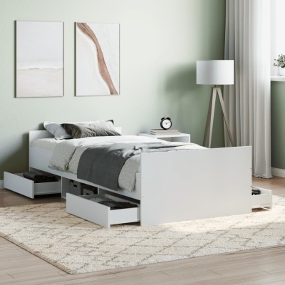 Cama branca com gavetas abertas e decoração minimalista num quarto moderno