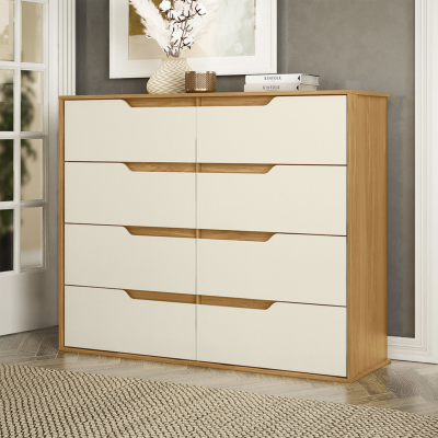 Cômoda de madeira com gavetas brancas e puxadores entalhados num ambiente interior