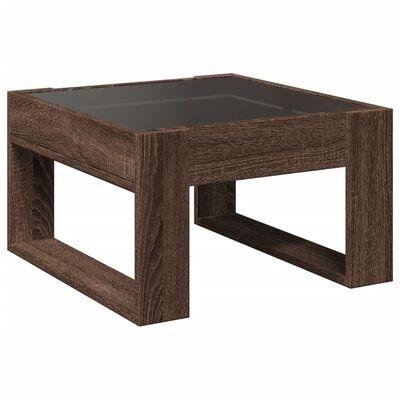 Mesa de centro quadrada em madeira escura com tampo de vidro preto.