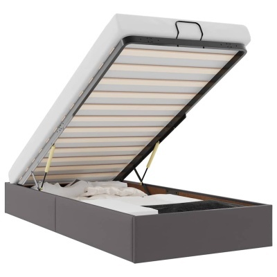 Cama cinza com sistema elevatório e colchão branco