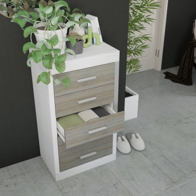 Cajonera branca com gavetas castanhas claras e planta verde no topo, em ambiente interior com piso de cimento e parede preta