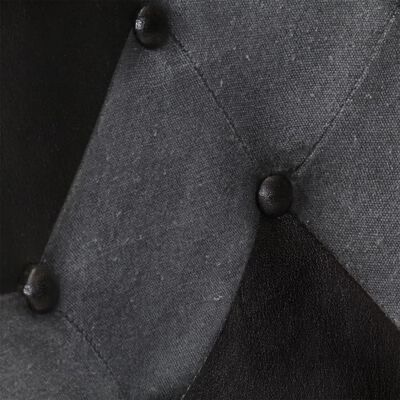 Detalhe de estofado cinza e preto com botões estofados