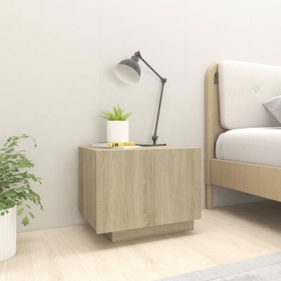 Criado-mudo de madeira clara numa decoração de quarto minimalista com planta e candeeiro