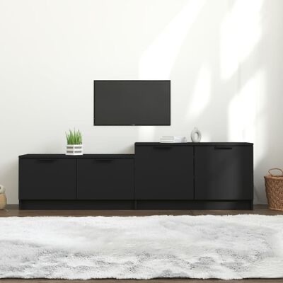 Móvel preto minimalista com plantas e decoração num espaço interior claro