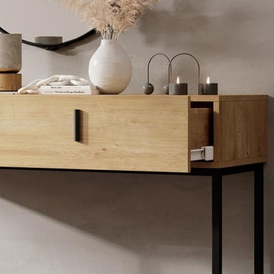 Mesa de madeira clara com pernas pretas e decoração minimalista