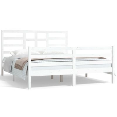 Cama de madeira branca com roupa de cama cinza e castanho