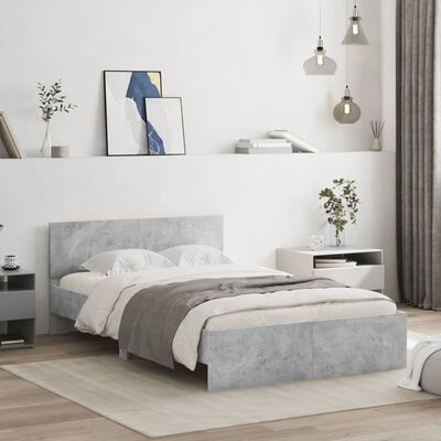 Quarto com cama de casal estofada cinzenta, candeeiros suspensos, mesas de cabeceira, quadros decorativos e planta