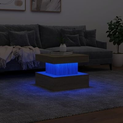 Mesa de centro quadrada com iluminação azul em sala moderna.