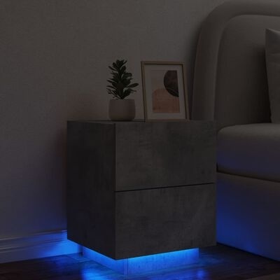Mesa de cabeceira cinzenta com iluminação azul e decoração ao lado da cama
