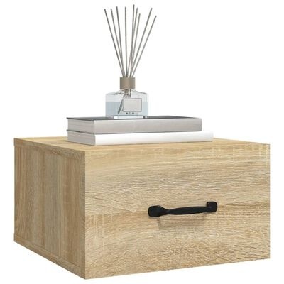 Mesa de cabeceira em madeira clara com livros e difusor de aromas