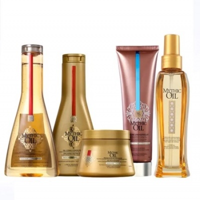 Conjunto de produtos capilares Mythic Oil com embalagens douradas e rosa metálico.