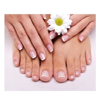 Mãos e pés femininos com unhas pintadas e flor margarida branca entre os dedos