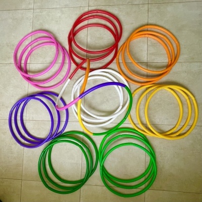 Aros coloridos dispostos no chão de azulejos claros