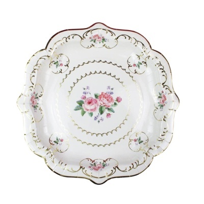 Prato decorativo de porcelana com flores rosas e detalhes dourados.