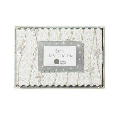 Conjunto de luzes de mesa em forma de estrelas com fios dourados numa caixa