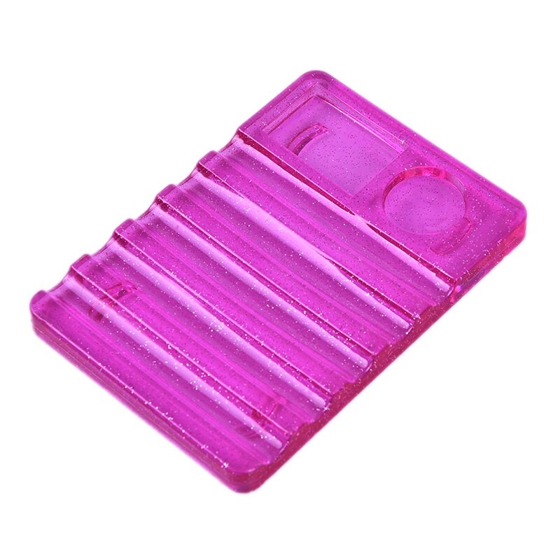 Peça de plástico translúcido rosa com ranhuras e forma circular