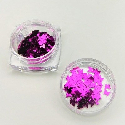Dois frascos pequenos com glitter rosa em formato de morcegos sobre fundo branco