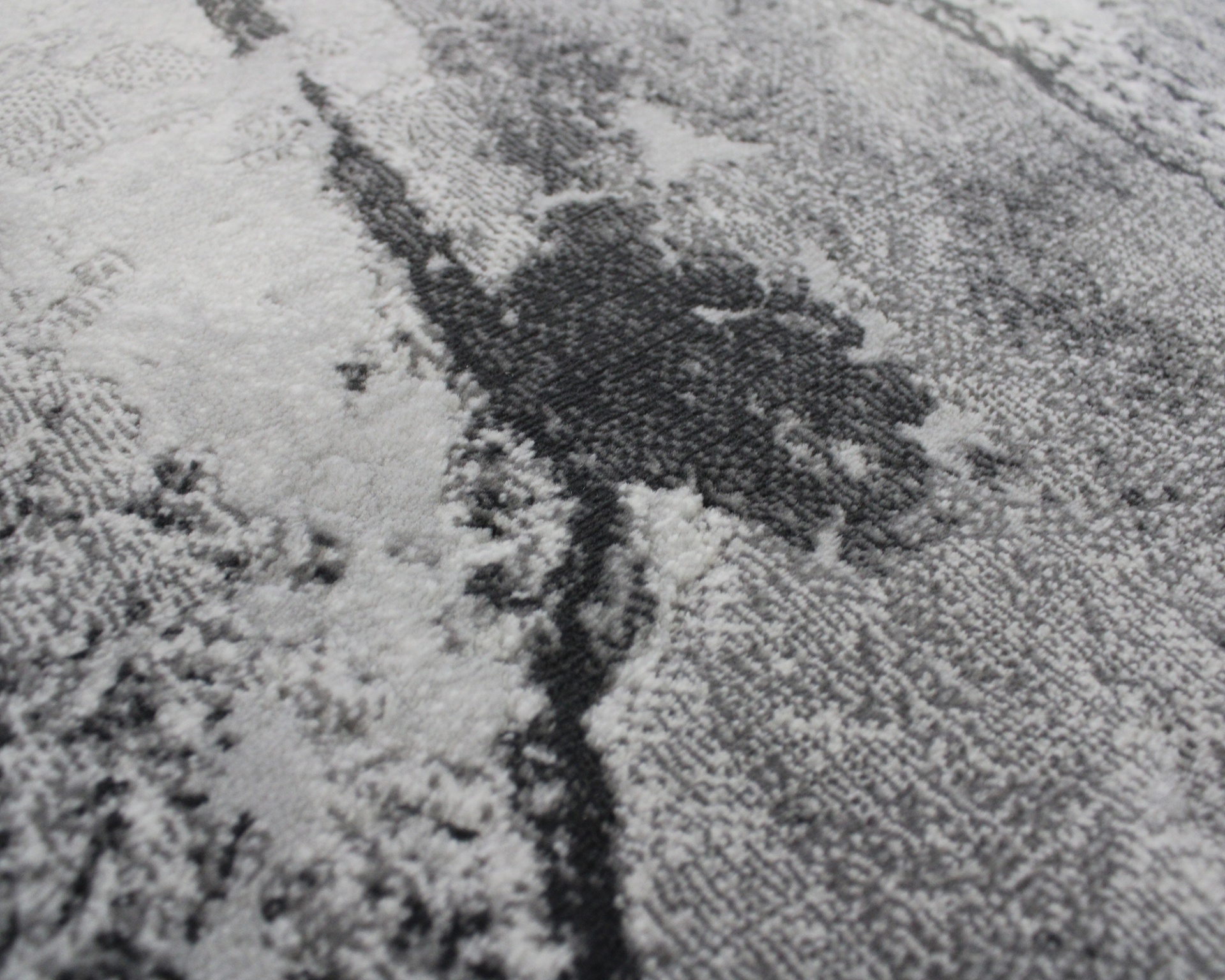 Padrão abstrato em tecido cinza, preto e branco com textura