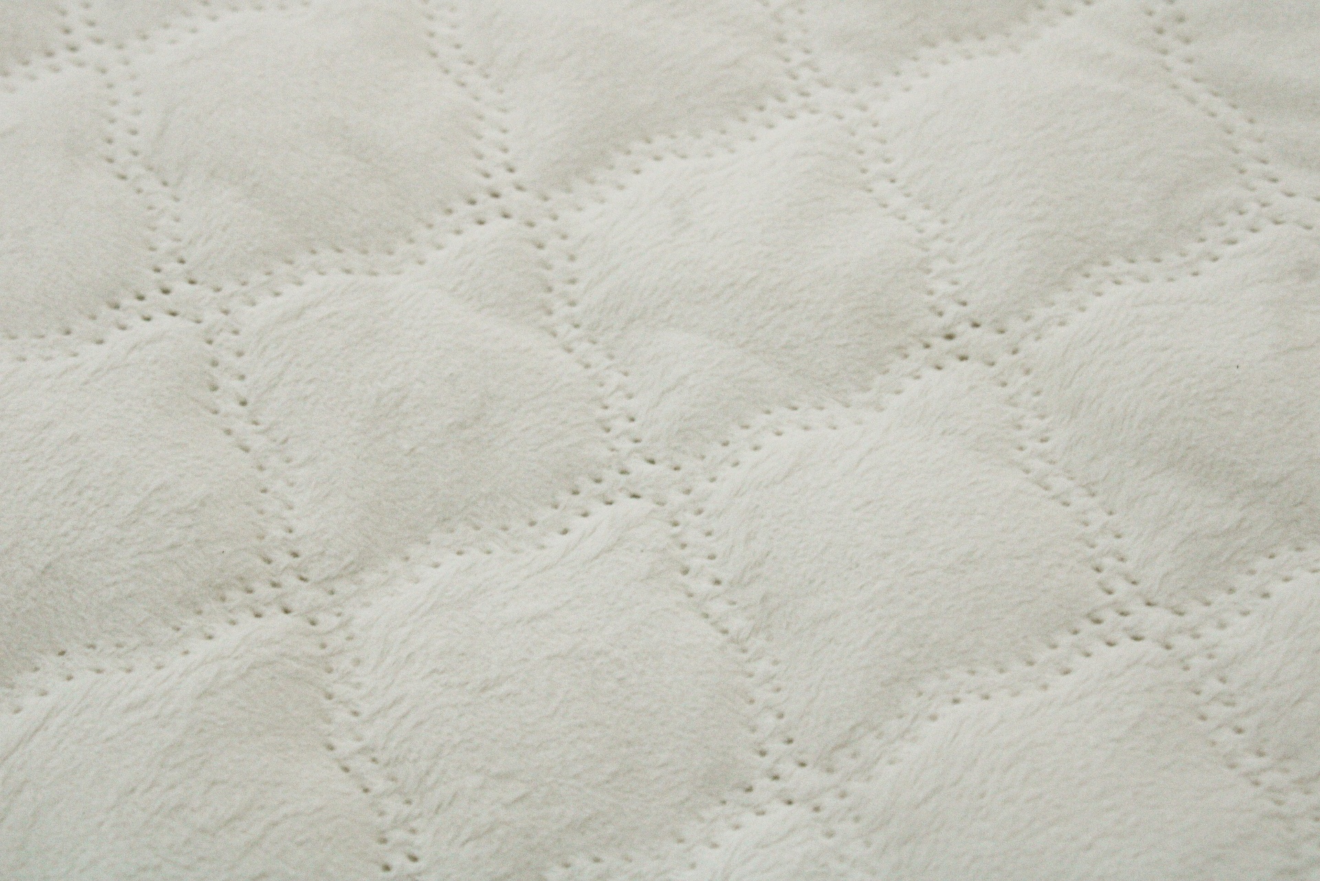 Tecido acolchoado branco com padrão de losangos