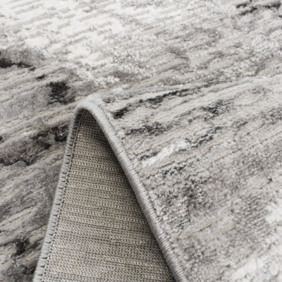 Tapete cinza abstrato com borda costurada e verso trançado