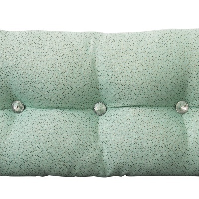 Travesseiro verde claro com pequenos pontos e botões decorativos