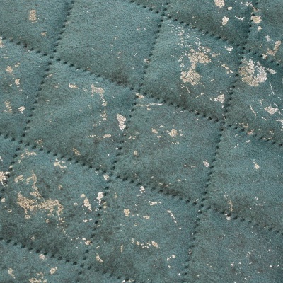 Tecido verde acolchoado com manchas douradas