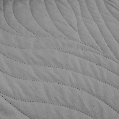 tecido cinzento claro acolchoado com padrão de linhas onduladas