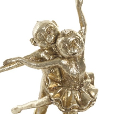 Estatueta dourada de dois macacos em pose de dança