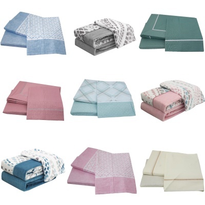 Conjuntos de roupa de cama em diferentes cores e padrões organizados em três filas sobre fundo branco