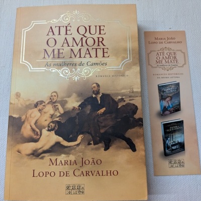 Capa do livro Até que o amor me mate com homem e mulheres nuas em tons castanhos e separador de página ao lado.