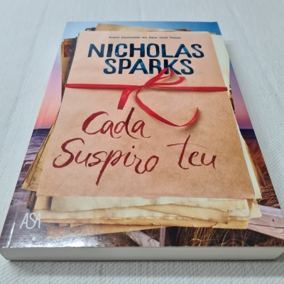 Livro 'Cada Suspiro Teu' de Nicholas Sparks com envelope e fita vermelha na capa