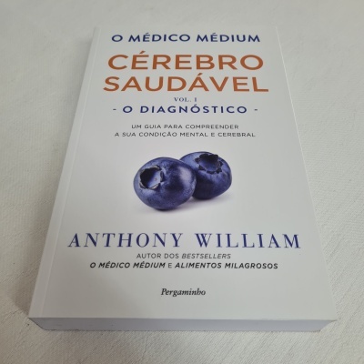 Livro 'O MÉDICO MÉDIUM CÉREBRO SAUDÁVEL Vol. 1' com dois mirtilos na capa