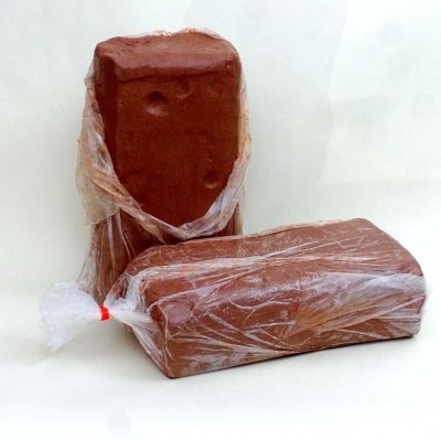 Dois tijolos vermelhos embalados em plástico transparente sobre fundo branco